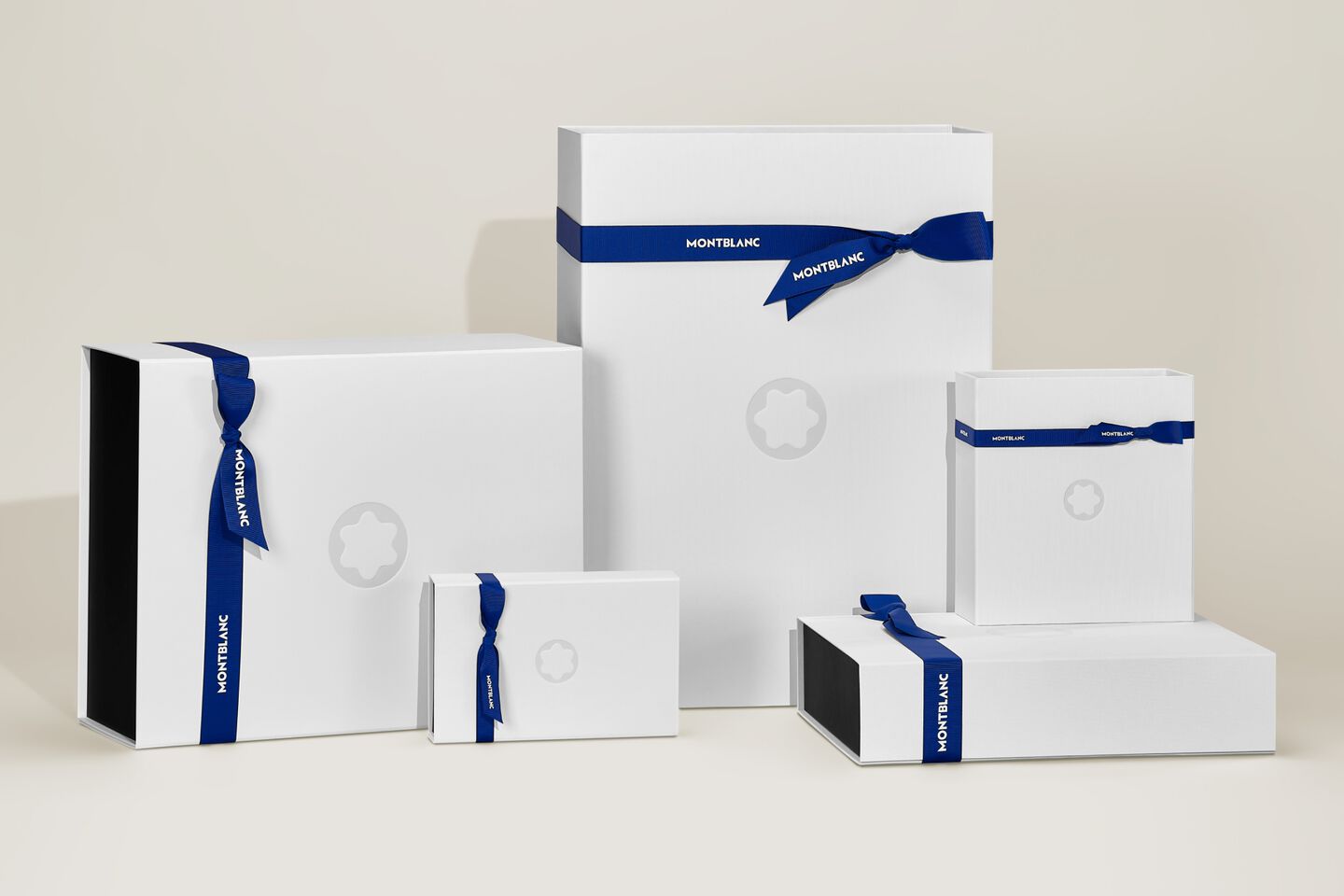 Montblanc gift boxes in various sizes, elegantly tied with satin ribbons, with the iconic emblem.